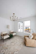 Living area featuring carpet and crown molding