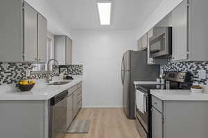 Kitchen with new quartz countertops and backsplash, freshly painted cabinets