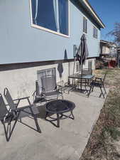 View of patio featuring an outdoor fire pit