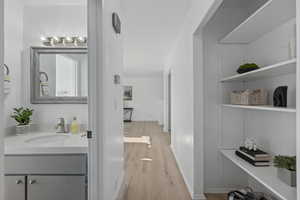 Upstairs hall and bathroom, featuring built-in shelves.