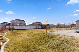 View of yard featuring a trampoline and a patio area