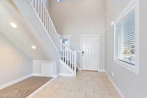 Tiled foyer entrance with a high ceiling