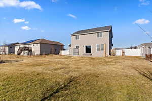 Back of house featuring a yard