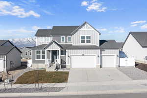 View of front facade with a garage and a mountain view