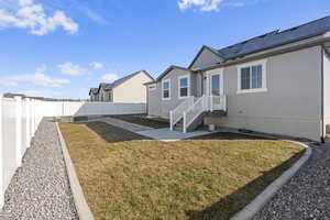 Exterior space featuring a lawn and solar panels