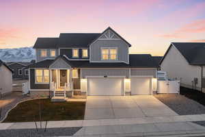 View of front facade featuring a garage and a mountain view