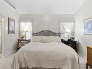 Bedroom featuring light colored carpet