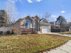 View of front of house with a front lawn and a garage