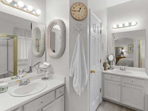 Bathroom featuring walk in shower, hardwood / wood-style floors, and vanity