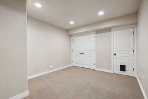 Unfurnished bedroom featuring light colored carpet and a closet