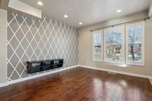 Unfurnished living room featuring dark hardwood / wood-style flooring