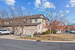 View of front of house featuring a front yard and a garage