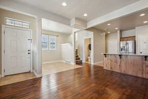 Foyer entrance with sink and light wood-type flooring