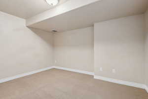 Unfurnished room featuring carpet flooring