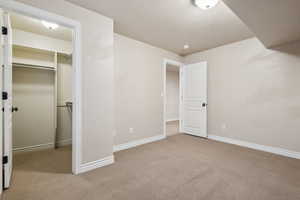 Unfurnished bedroom with a closet and light colored carpet