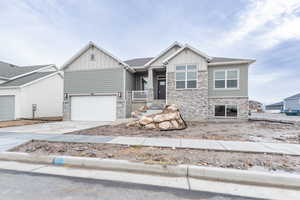 View of front of property featuring a porch and a garage