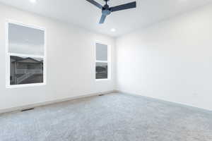 Unfurnished room with ceiling fan and carpet flooring