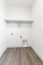 Clothes washing area featuring hardwood / wood-style flooring, washer hookup, and hookup for an electric dryer