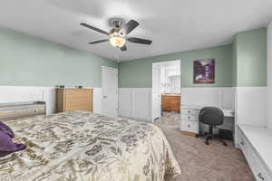 Carpeted bedroom with ceiling fan and en-suite bathroom