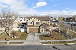 Front facade with a garage and a mountain view