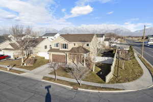 View of front of property featuring a garage and a mountain view