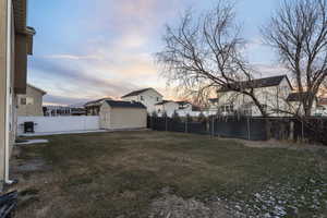 Yard at dusk with a storage shed