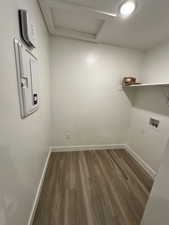 Laundry room featuring laundry area, attic access, washer hookup, and wood finished floors