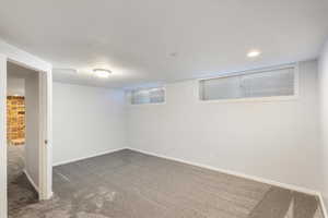 Basement with dark colored carpet