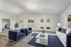 Living room featuring french doors and vaulted ceiling