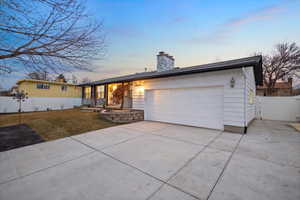 Ranch-style house with a lawn and a garage