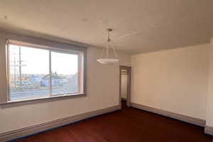 Unfurnished dining area featuring dark hardwood / wood-style flooring