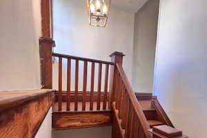 Staircase with an inviting chandelier