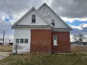 View of side of home featuring a yard