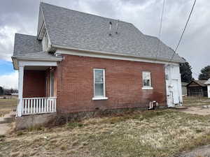 View of side of property featuring a yard