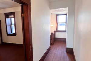 Hallway with hardwood / wood-style flooring