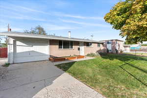 Single story home with a front lawn and a garage