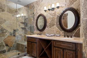 Bathroom featuring walk in shower and vanity