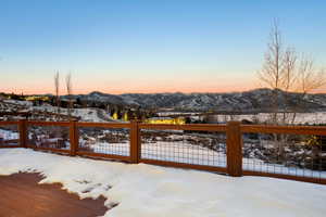 Snow covered patio featuring a mountain view