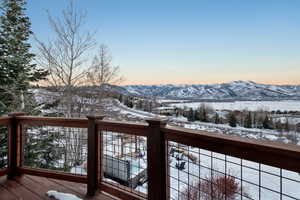 Snow covered deck with a mountain view