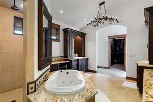 Bathroom with tile patterned floors, vanity, and shower with separate bathtub