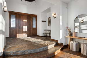 Foyer with a healthy amount of sunlight and dark hardwood / wood-style floors