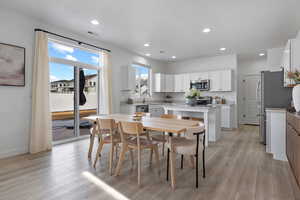 Dining room featuring sink and light hardwood / wood-style flooring