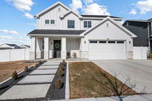 View of front of home featuring a porch and a garage
