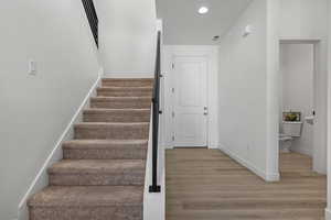 Staircase with hardwood / wood-style flooring
