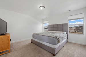 Bedroom with light colored carpet