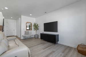 Living room with light hardwood / wood-style floors