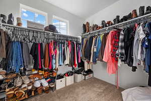 Walk in closet with carpet floors