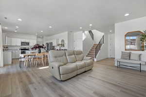 Living room with light hardwood / wood-style floors