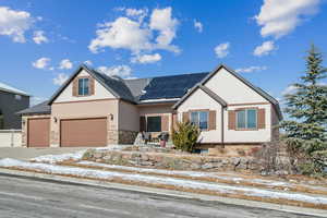 Craftsman-style house featuring a garage and solar panels