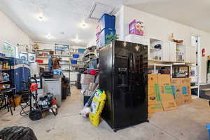 Interior space featuring black refrigerator with ice dispenser